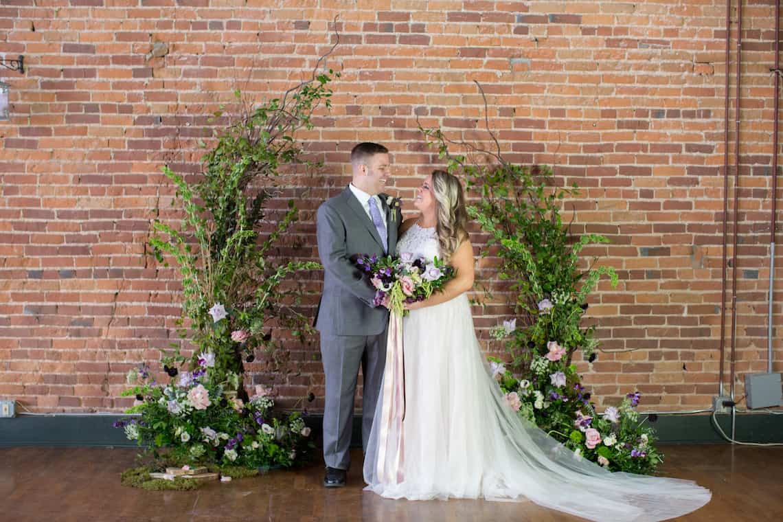 Bride and Groom with Naturally Created Arbor and Bouquet with Long Ribbons