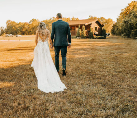 Heartland Lodge Kansas City WedKC Wedding Venue Yard Couple Walk Dress