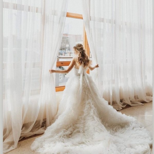 Bride Standing in front of curtains