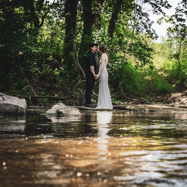 Cedar Valley Forest Kansas City Wedding Barn Venue WedKC Creek Kiss Couple