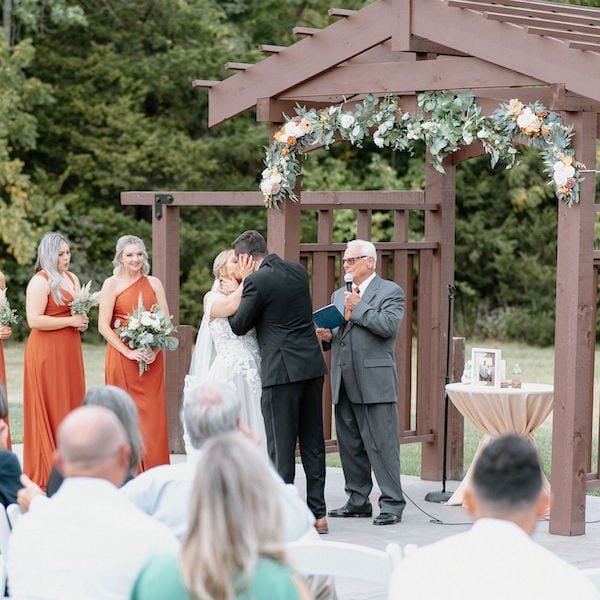 Heartland Lodge Kansas City WedKC Wedding Venue Ceremony Kiss Altar