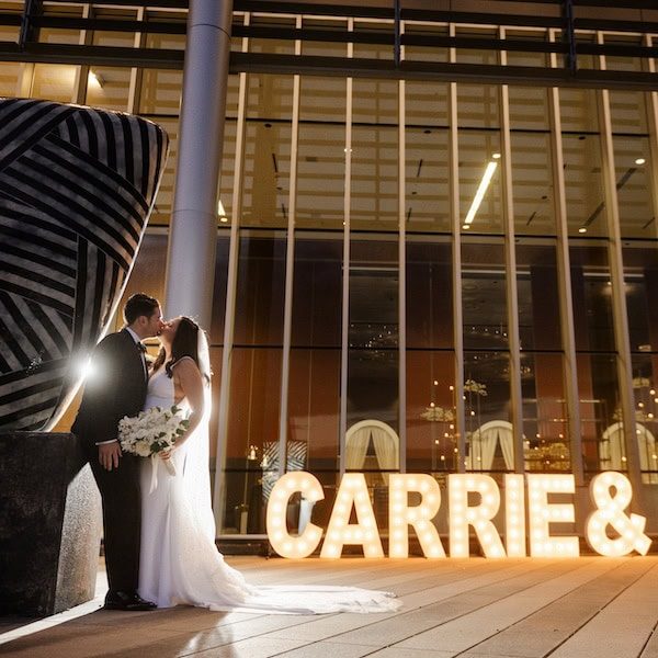 The Grand Ballroom at the Kansas City Convention Center Wedding WedKC Outside Light Up Letters Kiss